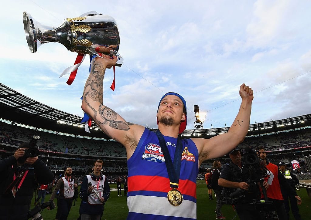 MELBOURNE, AUSTRALIA - OCTOBER 01: Clay Smith of the Bulldogs celebrates with the trophy after winning the 2016 AFL Grand Final match between the Sydney Swans and the Western Bulldogs at Melbourne Cricket Ground on October 1, 2016 in Melbourne, Australia. (Photo by Quinn Rooney/Getty Images)