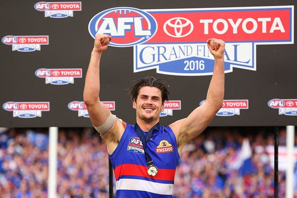 MELBOURNE, VICTORIA - OCTOBER 01: Tom Boyd of the Bulldogs celebrates the win on the podium during the 2016 AFL Grand Final match between the Sydney Swans and the Western Bulldogs at Melbourne Cricket Ground on October 1, 2016 in Melbourne, Australia. (Photo by Michael Dodge/AFL Media/Getty Images)