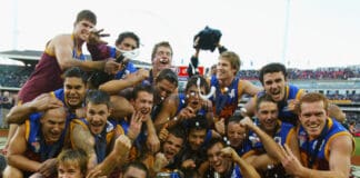 Brisbane celebrate with the trophy