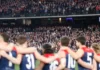 Players and spectators observe a minute's silence at the MCG. Picture: AFL Photos