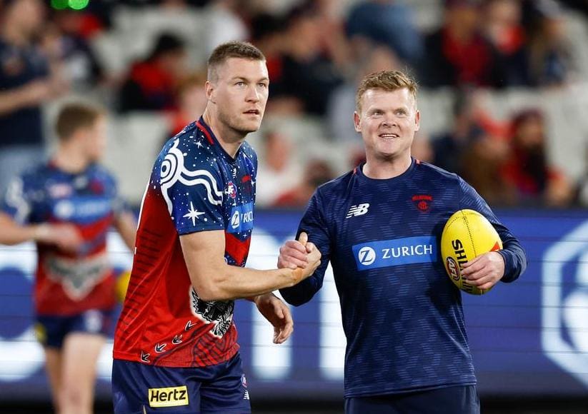 Tom McDonald shares a moment with Jim Plunkett before Melbourne's 2023 semi-final against Carlton. Credit: Michael Willson/AFL Photos via Getty Images