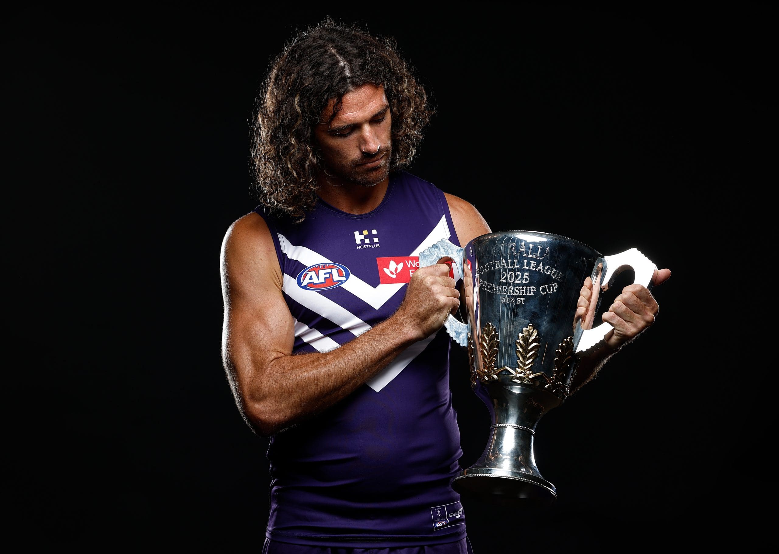 MELBOURNE, AUSTRALIA - FEBRUARY 24: Alex Pearce of the Dockers poses with the Premiership Cup during the 2025 AFL Captains Day at Marvel Stadium on February 24, 2025 in Melbourne, Australia. (Photo by Michael Willson/AFL Photos via Getty Images)