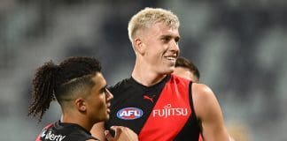 GEELONG, AUSTRALIA - FEBRUARY 25: Nate Caddy of the Bombers is congratulated by Isaac Kako of the Bombers after kicking a goal during the 2025 AAMI AFL Community Series match between Geelong Cats and Essendon Bombers at GMHBA Stadium on February 25, 2025 in Geelong, Australia. (Photo by Quinn Rooney/Getty Images)