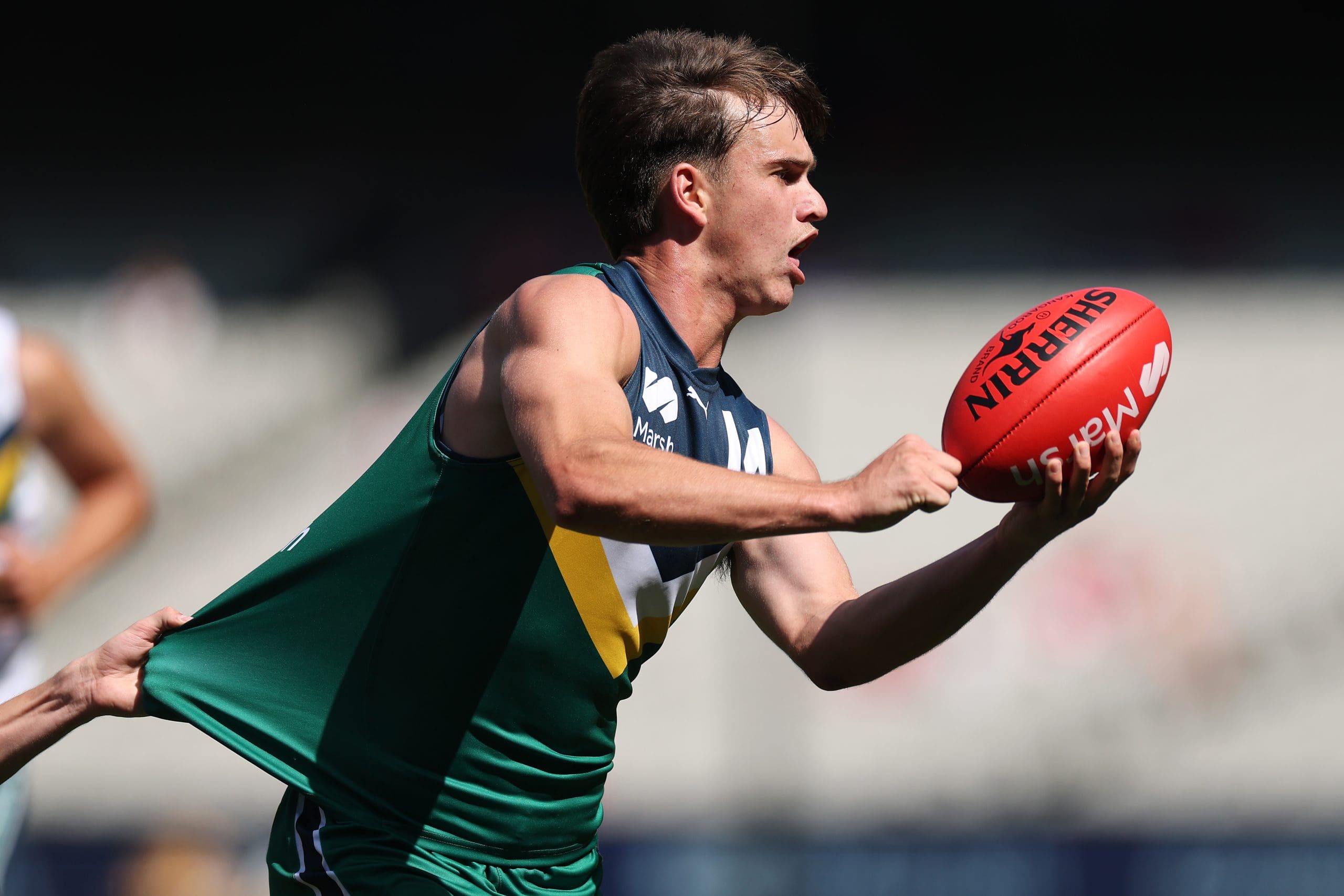 MELBOURNE, AUSTRALIA - SEPTEMBER 28: Daniel Annable of Team Heppell handballs during the Marsh AFL National Futures Boys match between Team Heppell and Team Sloane at Melbourne Cricket Ground, on September 28, 2024, in Melbourne, Australia. (Photo by Daniel Pockett/AFL Photos/via Getty Images)