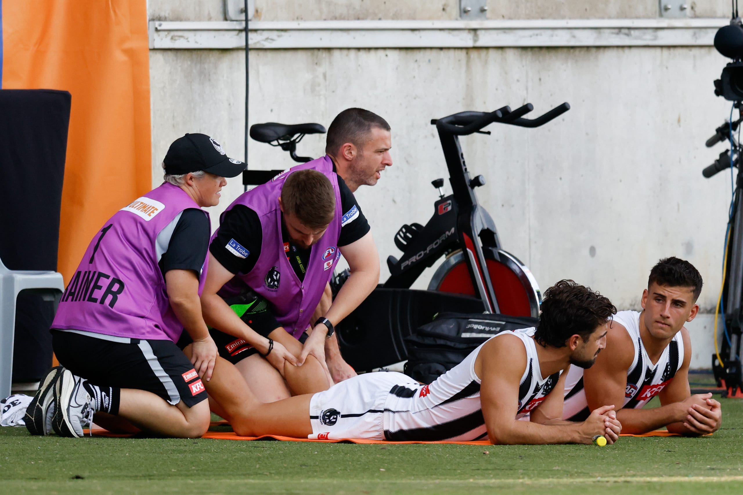 SYDNEY, AUSTRALIA - MARCH 09: Josh Daicos and Nick Daicos of the Magpies are seen receive treatment on the bench during the 2025 AFL Opening Round match between the GWS Giants and the Collingwood Magpies at ENGIE Stadium on March 9, 2025 in Sydney, Australia. (Photo by Dylan Burns/AFL Photos via Getty Images)