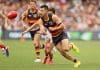 ADELAIDE, AUSTRALIA - MARCH 16: Alex Neal-Bullen of the Crows handpasses the ball during the 2025 AFL Round 01 match between the Adelaide Crows and the St Kilda Saints at Adelaide Oval on March 16, 2025 in Adelaide, Australia. (Photo by James Elsby/AFL Photos via Getty Images)