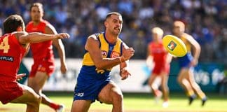 PERTH, AUSTRALIA - MARCH 16: Jack Graham of the Eagles handpasses the ball during the 2025 AFL Round 01 match between the West Coast Eagles and the Gold Coast Suns at Optus Stadium on March 16, 2025 in Perth, Australia. (Photo by Daniel Carson/AFL Photos via Getty Images)