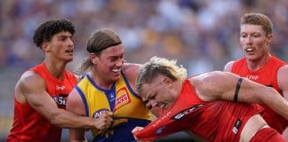 PERTH, AUSTRALIA - MARCH 16: Harley Reid of the Eagles wrestles with Nick Holman of the Suns during the round one AFL match between West Coast Eagles and Gold Coast Suns at Perth Stadium, on March 16, 2025, in Perth, Australia. (Photo by Paul Kane/Getty Images)
