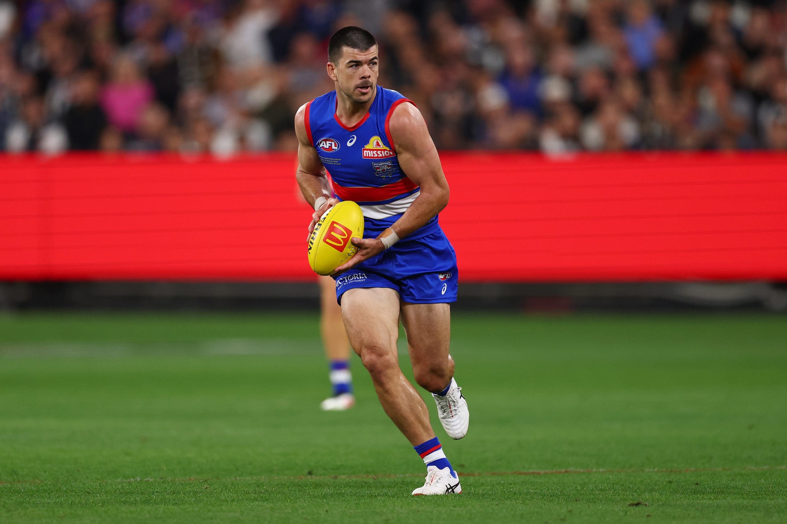MELBOURNE, AUSTRALIA - MARCH 21: Matthew Kennedy of the Bulldogs takes possession of the ball during the round two AFL match between Footscray Bulldogs (Western Bulldogs) and Collingwood Magpies at Melbourne Cricket Ground, on March 21, 2025, in Melbourne, Australia. (Photo by Morgan Hancock/AFL Photos/Getty Images)