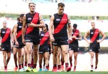 MELBOURNE, AUSTRALIA - MARCH 22: Mason Redman and Zach Merrett of the Bombers walk from the field following the round two AFL match between Essendon Bombers and Adelaide Crows at Melbourne Cricket Ground, on March 22, 2025, in Melbourne, Australia. (Photo by Morgan Hancock/AFL Photos/via Getty Images)