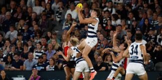MELBOURNE, AUSTRALIA - MARCH 22: Connor O'Sullivan of the Cats takes a high mark over teammate Zach Guthrie during the 2025 AFL Round 02 match between the St Kilda Saints and the Geelong Cats at Marvel Stadium on March 22, 2025 in Melbourne, Australia. (Photo by Michael Willson/AFL Photos)