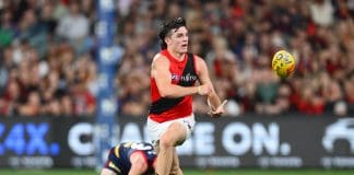 ADELAIDE, AUSTRALIA - APRIL 12: Archie Roberts of the Bombers handballs during the round five AFL match between Melbourne Demons and Essendon Bombers at Adelaide Oval, on April 12, 2025, in Adelaide, Australia. (Photo by Quinn Rooney/Getty Images via AFL Photos)
