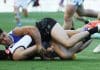 The Paul Curtis tackle on Josh Sinn. Picture: James Elsby/AFL Photos via Getty Images