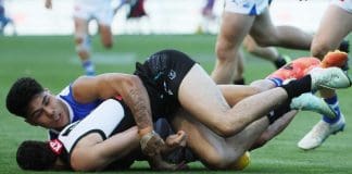 The Paul Curtis tackle on Josh Sinn. Picture: James Elsby/AFL Photos via Getty Images