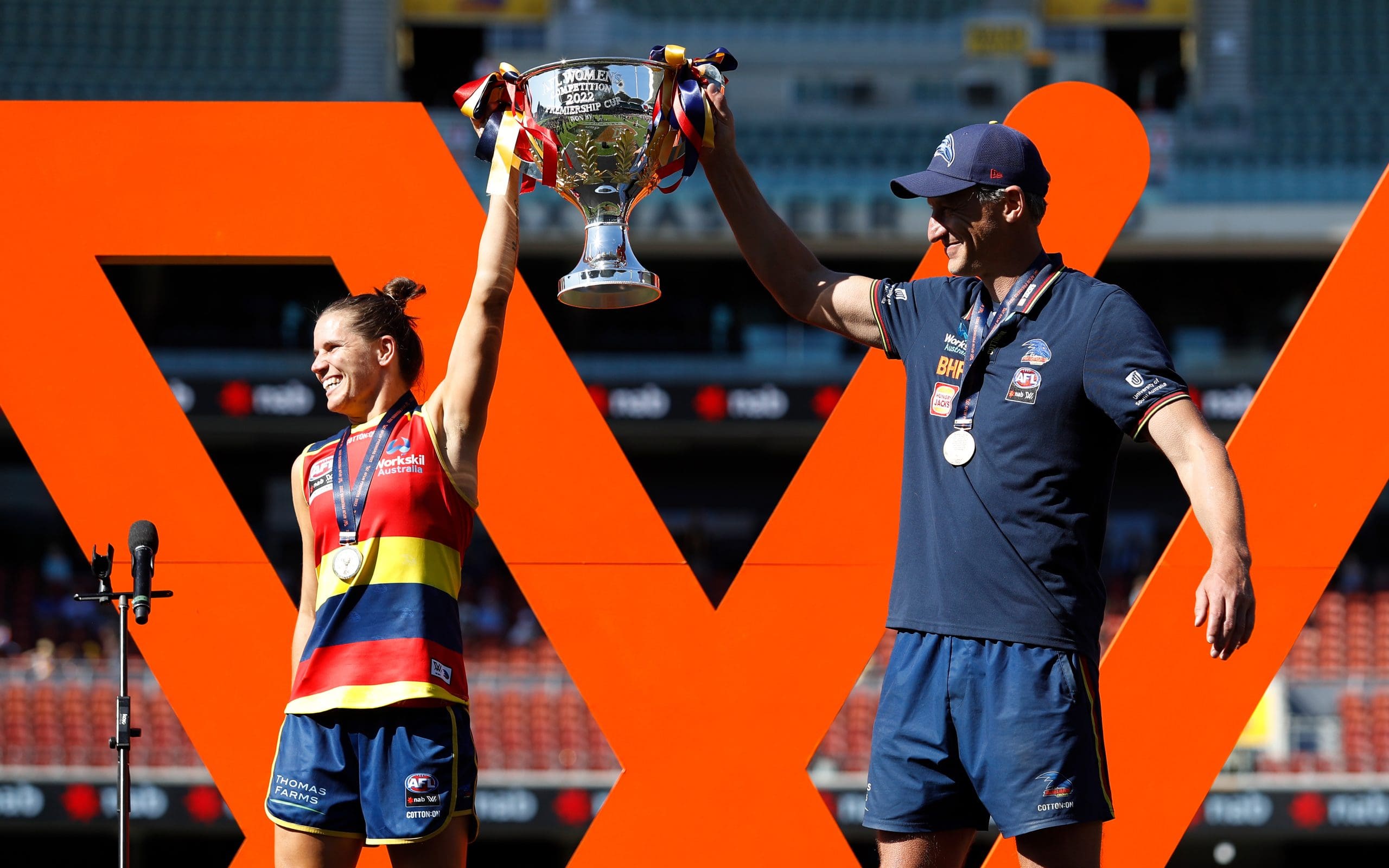 ADELAIDE, AUSTRALIA - APRIL 09: Chelsea Randall of the Crows and Matthew Clarke, Senior Coach of the Crows lift up the premiership cup during the 2022 AFLW Grand Final match between the Adelaide Crows and the Melbourne Demons at Adelaide Oval on April 09, 2022 in Adelaide, Australia. (Photo by Dylan Burns/AFL Photos via Getty Images)
