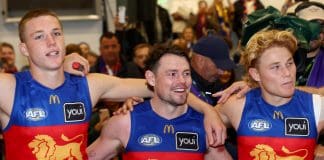 MELBOURNE, AUSTRALIA - APRIL 05: Logan Morris, Lachie Neale and Levi Ashcroft of the Lions sing the song in the rooms after winning the round four AFL match between Richmond Tigers and Brisbane Lions at Melbourne Cricket Ground, on April 05, 2025, in Melbourne, Australia. (Photo by Josh Chadwick/AFL Photos/via Getty Images)