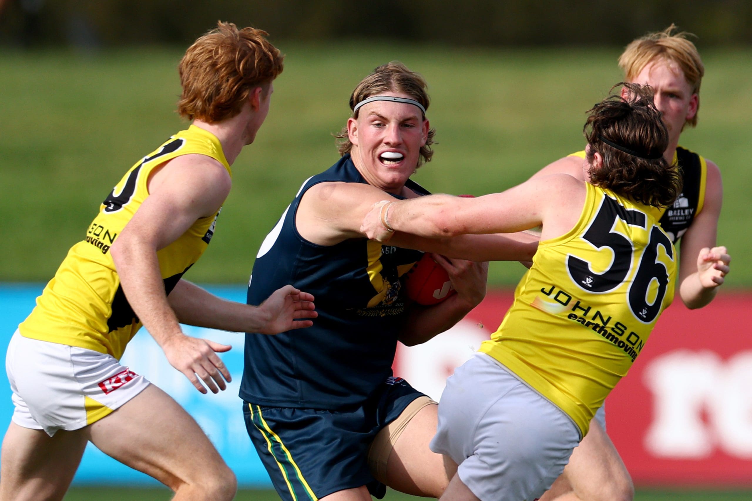 MELBOURNE, AUSTRALIA - APRIL 13: Oliver Greeves of the AFL National Academy is tackled by Lachlan Wilson of the Tigers during the Marsh AFL National Academy Boys match between Australia U18 and Richmond VFL at RSEA Park on April 13, 2025 in Melbourne, Australia. (Photo by Josh Chadwick/AFL Photos/via Getty Images)