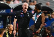 ADELAIDE, AUSTRALIA - APRIL 13: Ken Hinkley, Senior Coach of the Power speaks to Willie Rioli of the Power during the round five AFL match between Port Adelaide Power and Hawthorn Hawks at Adelaide Oval, on April 13, 2025, in Adelaide, Australia. (Photo by Quinn Rooney/Getty Images)