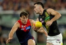 MELBOURNE, AUSTRALIA - APRIL 24: Seth Campbell of the Tigers handballs under pressure from Jack Viney of the Demons during the round seven AFL match between Melbourne Demons and Richmond Tigers at Melbourne Cricket Ground, on April 24, 2025, in Melbourne, Australia. (Photo by Robert Cianflone/Getty Images)