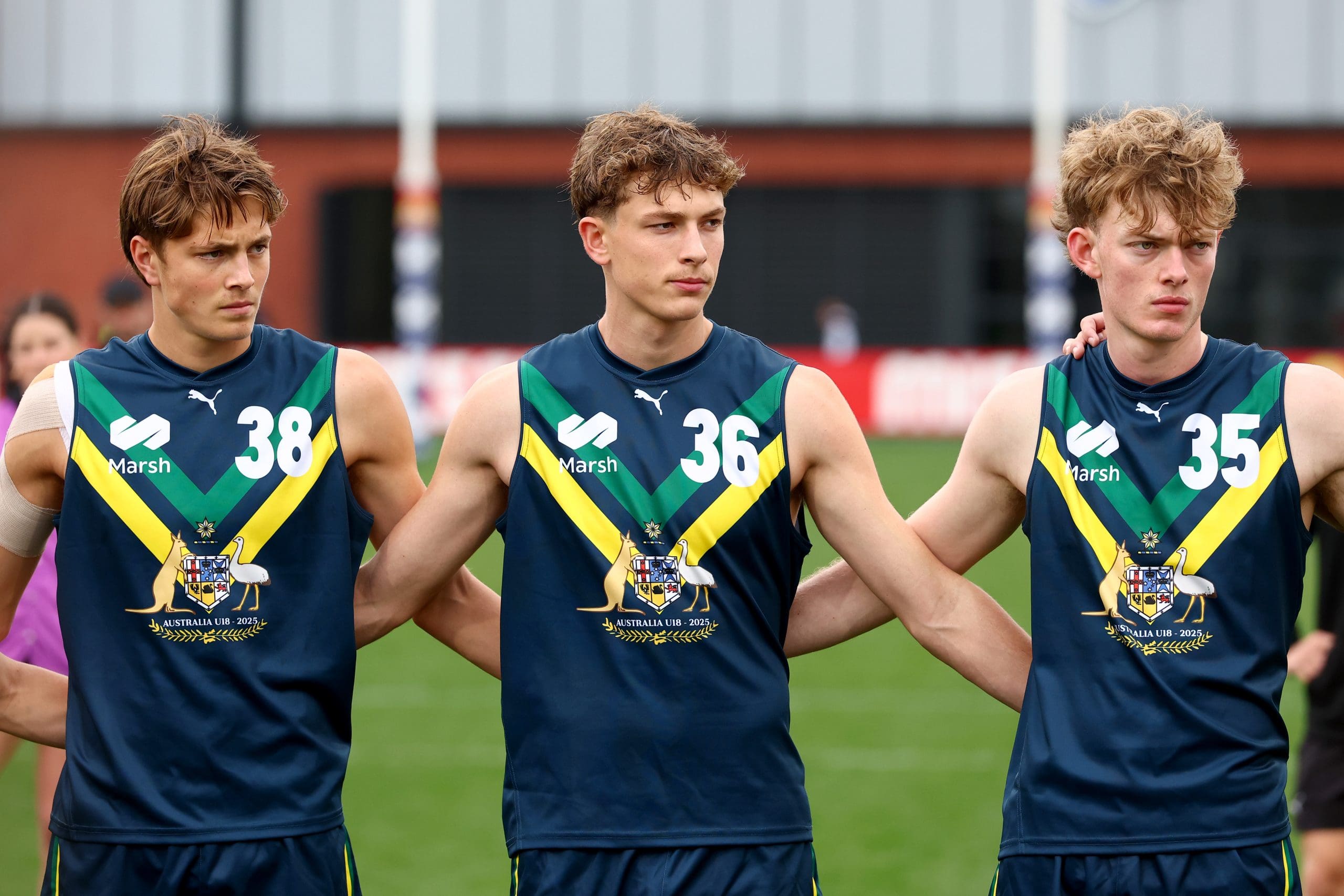 MELBOURNE, AUSTRALIA - APRIL 27: Archie Ludowyke, Liam Hetherton and Jasper Hay of the AFL National Academy huddle together for the Welcome to Country ahead of the Marsh AFL National Academy Boys match between Australia U18 and Coburg VFL at Whitten Oval on April 27, 2025 in Melbourne, Australia. (Photo by Josh Chadwick/AFL Photos/via Getty Images)