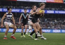 GEELONG, AUSTRALIA - MAY 10: Tom Atkins of the Cats tackles Jason Horne-Francis of the Power during the round nine AFL match between Geelong Cats and Port Adelaide Power at GMHBA Stadium, on May 10, 2024, in Geelong, Australia. (Photo by Darrian Traynor/Getty Images)