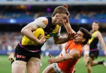 MELBOURNE, AUSTRALIA - JULY 14: Tom Brown of the Tigers is tackled by Tom Green of the Giants during the 2024 AFL Round 18 match between the Richmond Tigers and the GWS GIANTS at Melbourne Cricket Ground on July 14, 2024 in Melbourne, Australia. (Photo by Michael Willson/AFL Photos via Getty Images)
