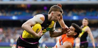 MELBOURNE, AUSTRALIA - JULY 14: Tom Brown of the Tigers is tackled by Tom Green of the Giants during the 2024 AFL Round 18 match between the Richmond Tigers and the GWS GIANTS at Melbourne Cricket Ground on July 14, 2024 in Melbourne, Australia. (Photo by Michael Willson/AFL Photos via Getty Images)