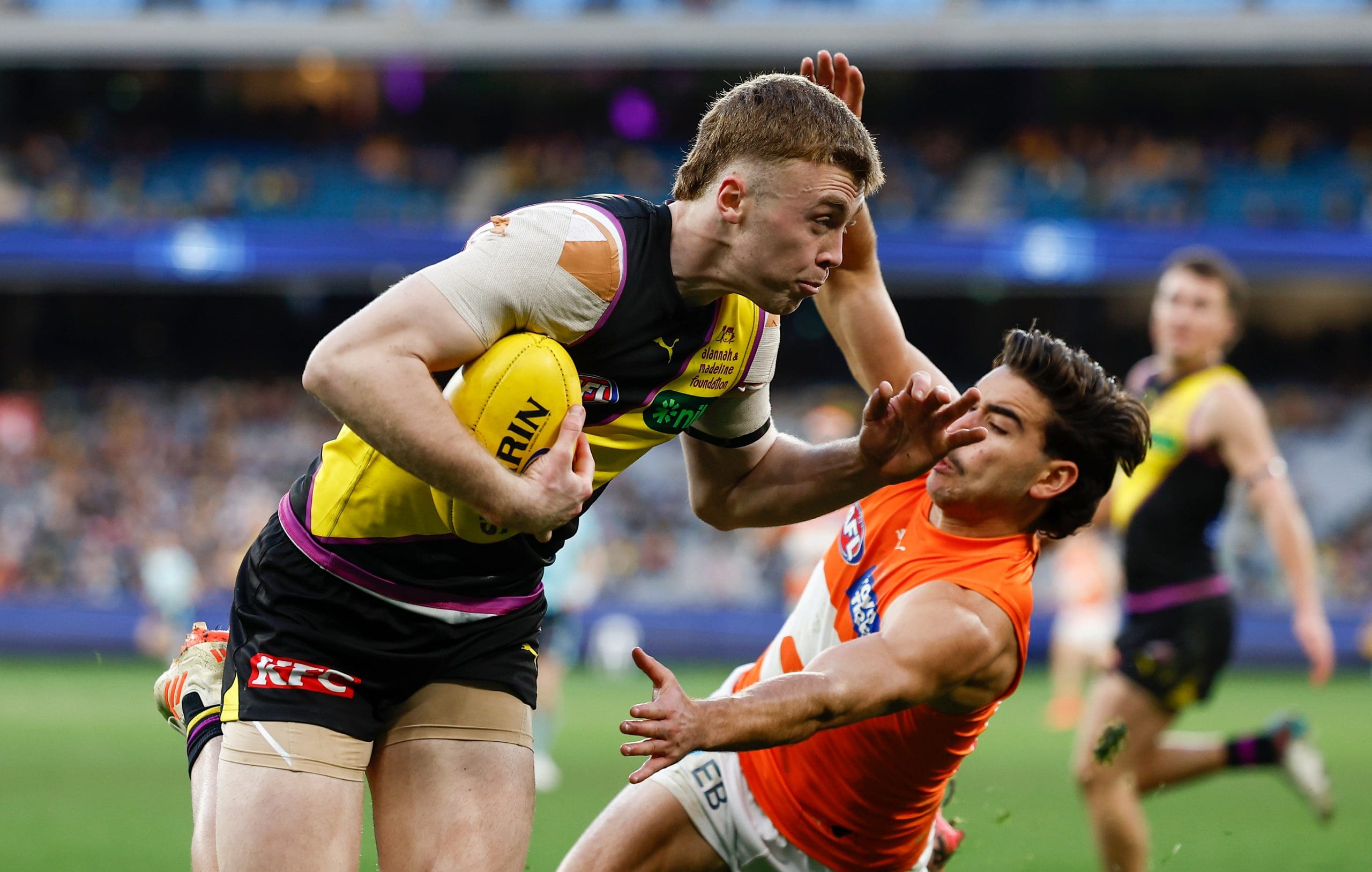 MELBOURNE, AUSTRALIA - JULY 14: Tom Brown of the Tigers is tackled by Tom Green of the Giants during the 2024 AFL Round 18 match between the Richmond Tigers and the GWS GIANTS at Melbourne Cricket Ground on July 14, 2024 in Melbourne, Australia. (Photo by Michael Willson/AFL Photos via Getty Images)