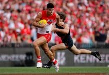 SYDNEY, AUSTRALIA - SEPTEMBER 07: Lewis Melican of the Swans evades Callan Ward of the Giants during the 2024 AFL First Qualifying Final match between the Sydney Swans and the GWS GIANTS at The Sydney Cricket Ground on September 07, 2024 in Sydney, Australia. (Photo by Dylan Burns/AFL Photos via Getty Images)