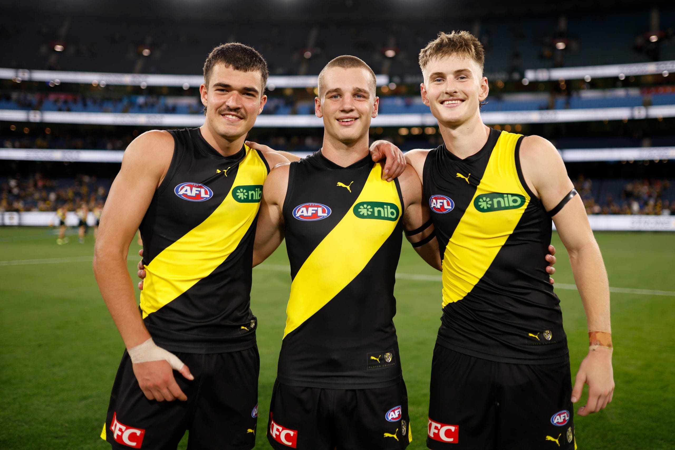 MELBOURNE, AUSTRALIA - MARCH 13: Richmond debutants Harry Armstrong, Sam Lalor and Luke Trainor pose for a photo after a win during the 2025 AFL Round 01 match between the Richmond Tigers and the Carlton Blues at the Melbourne Cricket Ground on March 13, 2025 in Melbourne, Australia. (Photo by Dylan Burns/AFL Photos via Getty Images)