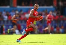 GOLD COAST, AUSTRALIA - APRIL 05: Touk Miller of the Suns handles the ball during the round four AFL match between Gold Coast Suns and Adelaide Crows at People First Stadium, on April 05, 2025, in Gold Coast, Australia. (Photo by Matt Roberts/AFL Photos/via Getty Images)