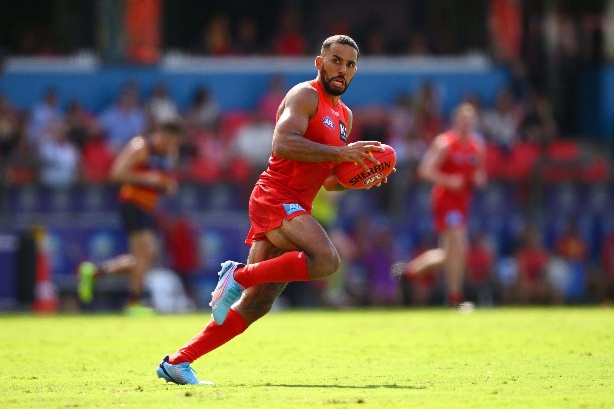 GOLD COAST, AUSTRALIA - APRIL 05: Touk Miller of the Suns handles the ball during the round four AFL match between Gold Coast Suns and Adelaide Crows at People First Stadium, on April 05, 2025, in Gold Coast, Australia. (Photo by Matt Roberts/AFL Photos/via Getty Images)