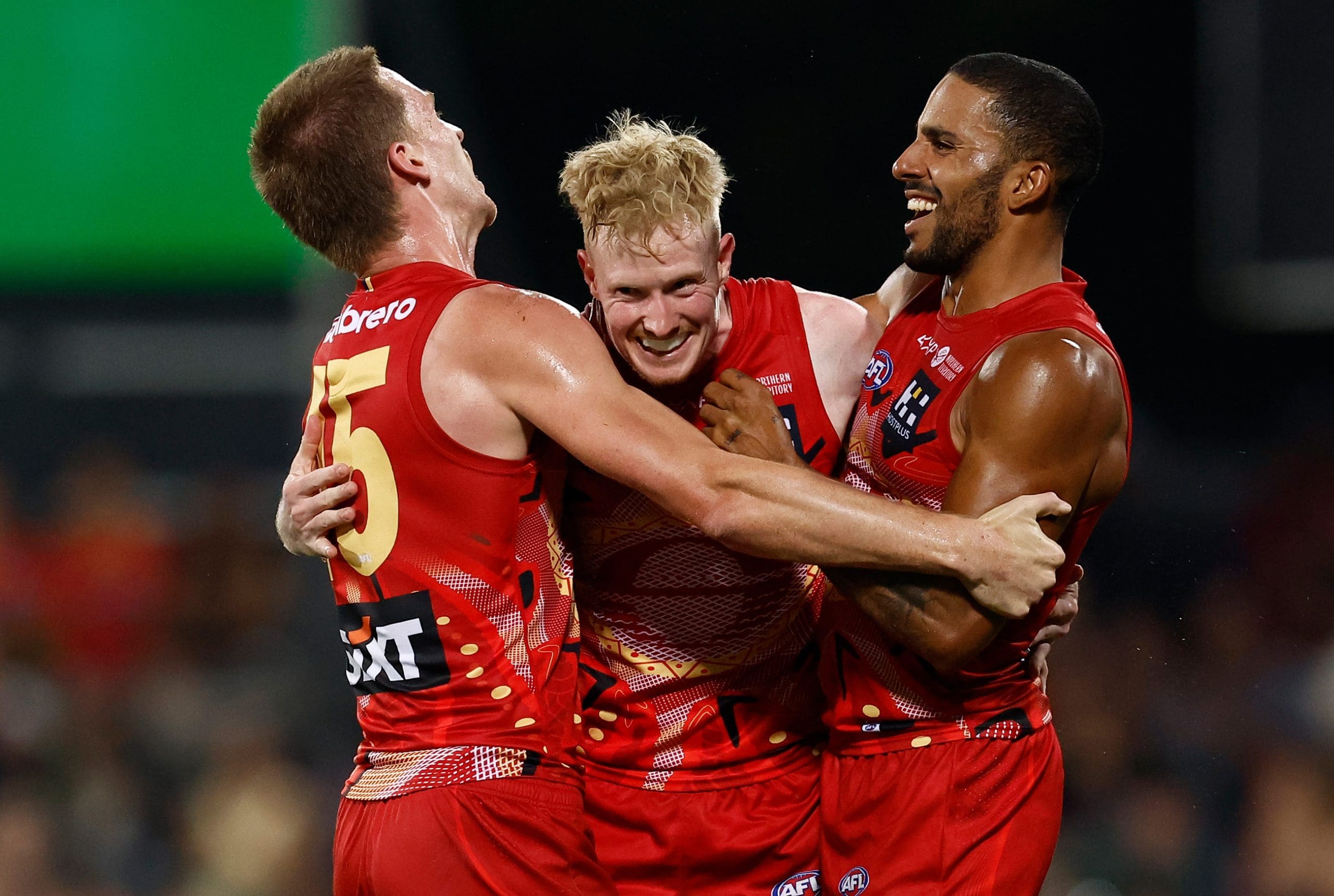DARWIN, AUSTRALIA - MAY 10: (L-R) Noah Anderson, John Noble and Touk Miller of the Suns celebrate during the 2025 AFL Round 09 match between the Gold Coast Suns and the Western Bulldogs at TIO Stadium on May 10, 2025 in Darwin, Australia. (Photo by Michael Willson/AFL Photos via Getty Images)