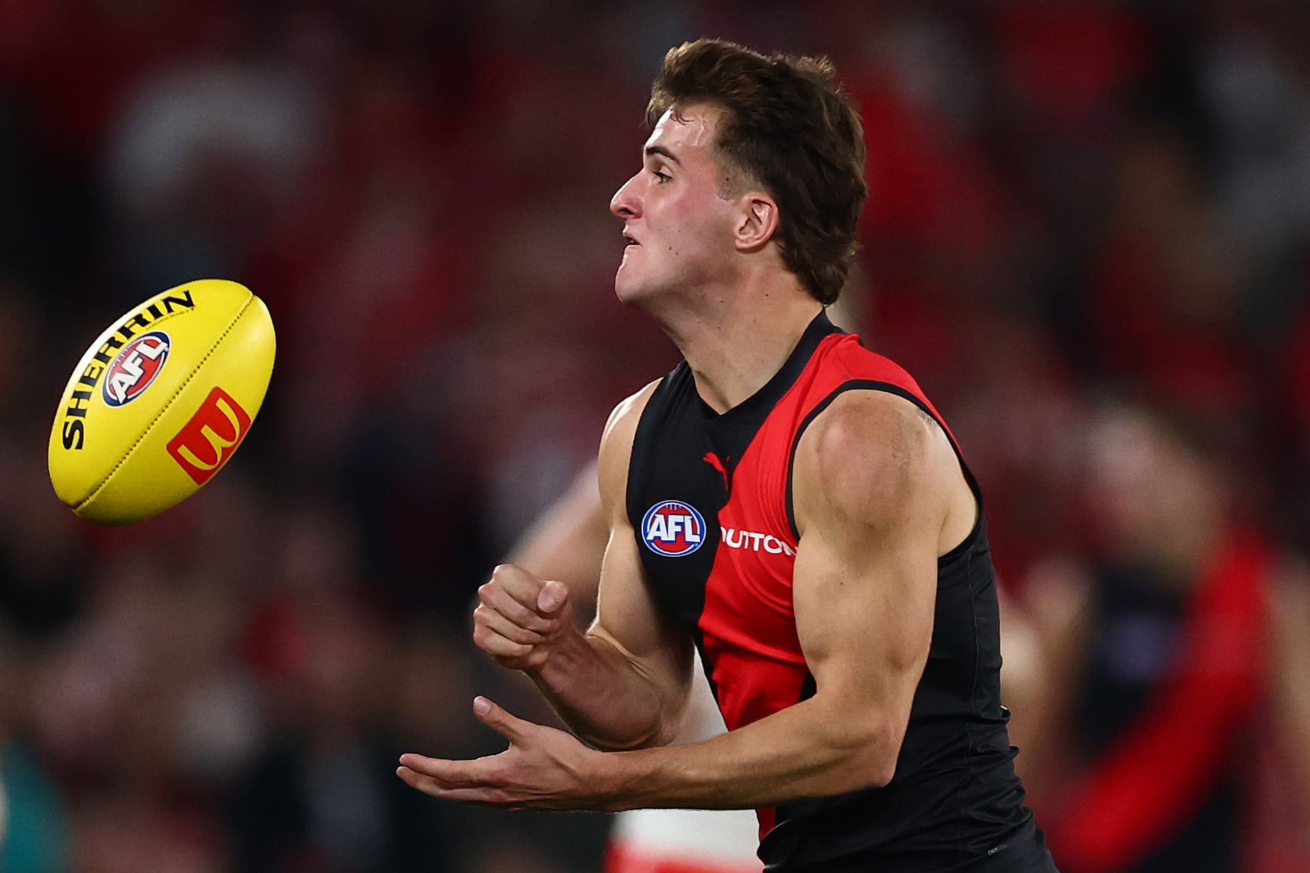 MELBOURNE, AUSTRALIA - MAY 10: Archer Day-Wicks of the Bombers takes possession of the ball during the round nine AFL match between Essendon Bombers and Sydney Swans at Marvel Stadium, on May 10, 2025, in Melbourne, Australia. (Photo by Morgan Hancock/Getty Images)