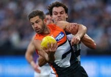 GEELONG, AUSTRALIA - MAY 11: Callan Ward of the Giants is tackled during the round nine AFL match between Geelong Cats and GWS Giants at GMHBA Stadium on May 11, 2025 in Geelong, Australia. (Photo by Graham Denholm/AFL Photos/Getty Images)