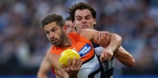 GEELONG, AUSTRALIA - MAY 11: Callan Ward of the Giants is tackled during the round nine AFL match between Geelong Cats and GWS Giants at GMHBA Stadium on May 11, 2025 in Geelong, Australia. (Photo by Graham Denholm/AFL Photos/Getty Images)