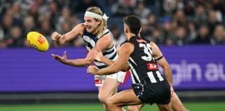 MELBOURNE, AUSTRALIA - MAY 03: Bailey Smith of the Cats handballs whilst being tackled during the round eight AFL match between Collingwood Magpies and Geelong Cats at Melbourne Cricket Ground, on May 03, 2025, in Melbourne, Australia. (Photo by Quinn Rooney/Getty Images)