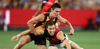 MELBOURNE, AUSTRALIA - MARCH 14: Zach Merrett of the Bombers is tackled by Connor Macdonald of the Hawks during the round one AFL match between Hawthorn Hawks and Essendon Bombers at Melbourne Cricket Ground, on March 14, 2025, in Melbourne, Australia. (Photo by Quinn Rooney/Getty Images)