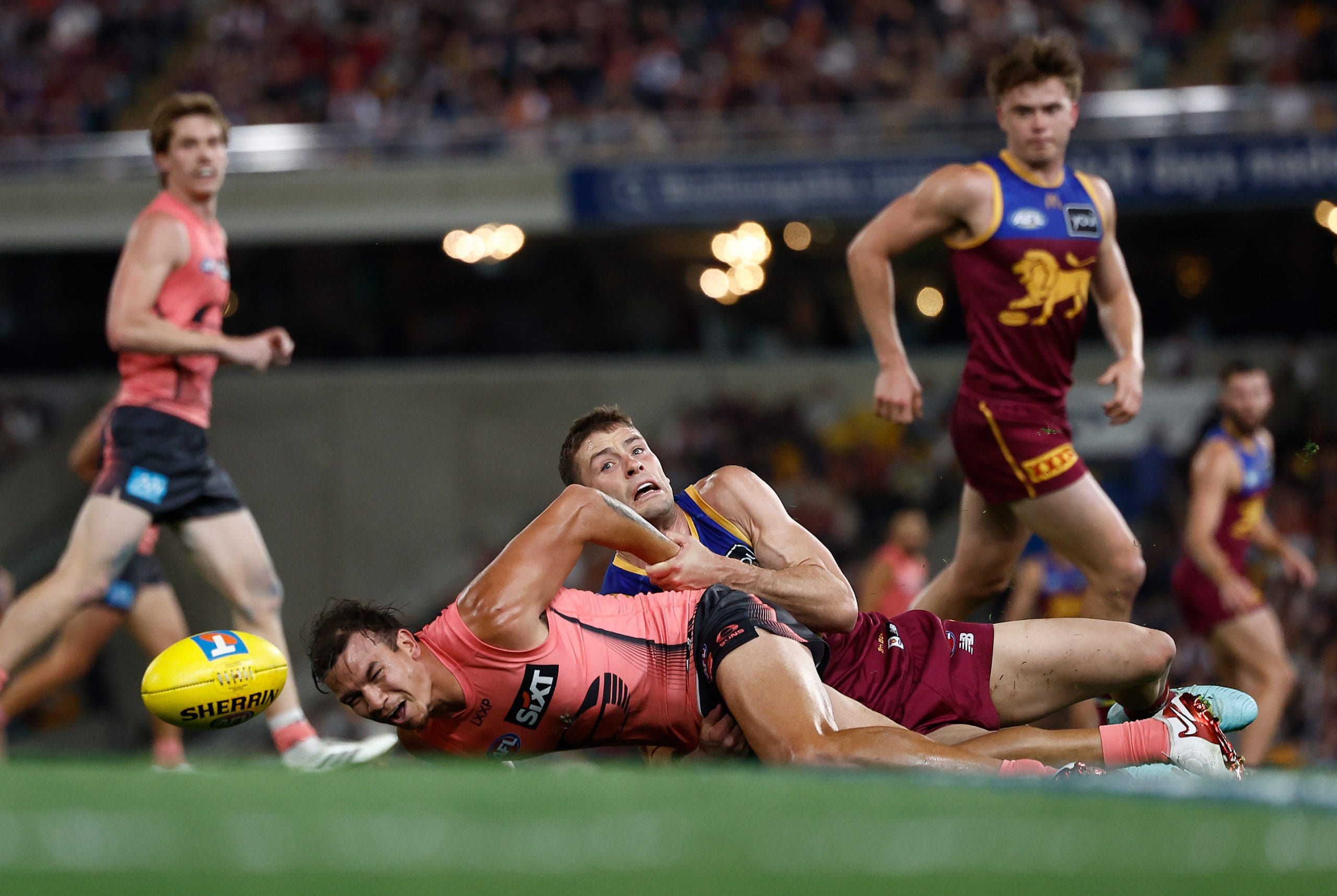 BRISBANE, AUSTRALIA - SEPTEMBER 13: Daniel Rioli of the Suns is tackled by Josh Dunkley of the Lions during the AFL Second Semi Final match between the Brisbane Lions and the Gold Coast Suns at the Gabba on September 13, 2025 in Brisbane, Australia. (Photo by Michael Willson/AFL Photos via Getty Images)