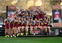 MELBOURNE, AUSTRALIA - SEPTEMBER 27: The Lions celebrate on the dais after winning the AFL Grand Final match between the Geelong Cats and the Brisbane Lions at the Melbourne Cricket Ground on September 27, 2025 in Melbourne, Australia. (Photo by Michael Willson/AFL Photos via Getty Images)