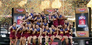MELBOURNE, AUSTRALIA - SEPTEMBER 27: The Lions celebrate on the dais after winning the AFL Grand Final match between the Geelong Cats and the Brisbane Lions at the Melbourne Cricket Ground on September 27, 2025 in Melbourne, Australia. (Photo by Michael Willson/AFL Photos via Getty Images)