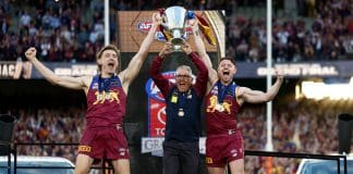MELBOURNE, AUSTRALIA - SEPTEMBER 27: Harris Andrews of the Lions, Chris Fagan, Senior Coach of the Lions and Lachie Neale of the Lions celebrate with the Premiership Cup on the dais during the AFL Grand Final match between the Geelong Cats and the Brisbane Lions at the Melbourne Cricket Ground on September 27, 2025 in Melbourne, Australia. (Photo by Michael Willson/AFL Photos via Getty Images)