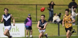PERTH, AUSTRALIA - JULY 06: Thomas Burton of Victoria Metro handballs during the Marsh AFL National Championships U18 Boys match between Western Australia and Victoria Metro at The Good Grocer Park, on July 06, 2025, in Perth, Australia. (Photo by Stefan Gosatti/AFL Photos/via Getty Images)