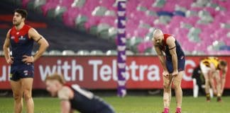 MELBOURNE, AUSTRALIA - JULY 17: Max Gawn of the Demons (2R), Christian Petracca of the Demons (L) and Clayton Oliver of the Demons look dejected after the match resulted in a draw in the round 18 AFL match between Melbourne Demons and Hawthorn Hawks at Melbourne Cricket Ground on July 17, 2021 in Melbourne, Australia. (Photo by Daniel Pockett/AFL Photos/via Getty Images)