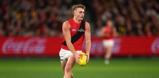 MELBOURNE, AUSTRALIA - JULY 12: Oskar Smartt of the Bombers runs with the ball during the round 18 AFL match between Richmond Tigers and Essendon Bombers at Melbourne Cricket Ground on July 12, 2025 in Melbourne, Australia. (Photo by Morgan Hancock/Getty Images)