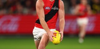 MELBOURNE, AUSTRALIA - JULY 12: Oskar Smartt of the Bombers runs with the ball during the round 18 AFL match between Richmond Tigers and Essendon Bombers at Melbourne Cricket Ground on July 12, 2025 in Melbourne, Australia. (Photo by Morgan Hancock/Getty Images)