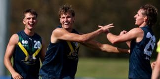 MELBOURNE, AUSTRALIA - APRIL 13: Cooper Duff-Tytler of the AFL National Academy is congratulated by team mates after kicking a goal during the Marsh AFL National Academy Boys match between Australia U18 and Richmond VFL at RSEA Park on April 13, 2025 in Melbourne, Australia. (Photo by Josh Chadwick/AFL Photos)