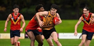 PERTH, AUSTRALIA - JUNE 21: Axel Walsh of Western Australia is tackled by Bemes Pilot of South Australia during the 2025 Marsh AFL National Development Championships U16 Boys match between Western Australia and South Australia at HIF Health Insurance Oval on June 21, 2025 in Perth, Australia. (Photo by Daniel Carson/AFL Photos via Getty Images)