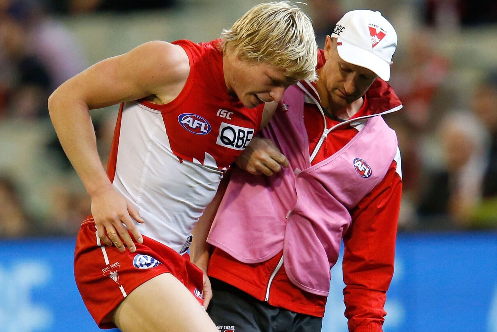 MELBOURNE, VICTORIA - MAY 09: Isaac Heeney of the Swans is helped from the field during the round six AFL match between the Melbourne Demons and the Sydney Swans at Melbourne Cricket Ground on May 9, 2015 in Melbourne, Australia. (Photo by Darrian Traynor/AFL/Getty Images)