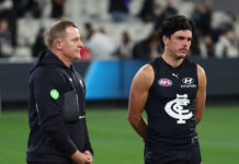 MELBOURNE, AUSTRALIA - APRIL 16: Michael Voss, Senior Coach of the Blues and Elijah Hollands of the Blues after the game during the 2026 AFL Round 06 match between the Carlton Blues and the Collingwood Magpies at the Melbourne Cricket Ground on April 16, 2026 in Melbourne, Australia. (Photo by James Wiltshire/AFL Photos via Getty Images)